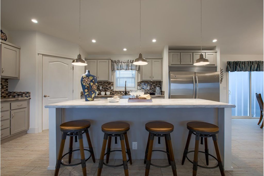 modular home kitchen view with bar stools