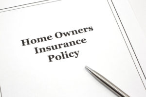 A home owners insurance policy with a pen ready to be signed.